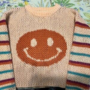 Short smiley sweater. Peach with turquoise purple and orange stripes.
